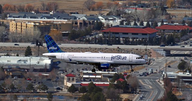Airbus A320 (N705JB) - N705JB, jetBlue's A320 aptly named "Big Blue People Seater," is clicked from the top of The Snake as it passes over Neil Road while on its s/final to 34L at the end of a late morning flight from LAX.br /The highway running left to right in the background is Interstate 580/Interstate 395.