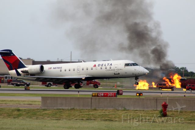 Canadair Regional Jet CRJ-200 (N878AS) - Delta CRJ-200 Landing on runway 12R at MSP with a fire/emergency practice occurring in the background. Photo taken 6/7/2017.