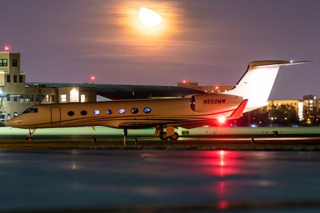 Gulfstream Aerospace Gulfstream V (N552MW) - G-V came in tonight. Unfortunately they parked it way over by Hangar 4 for whatever reason. Still managed this cool shot with the moon rising and Purdue's CRJ and G-IV.