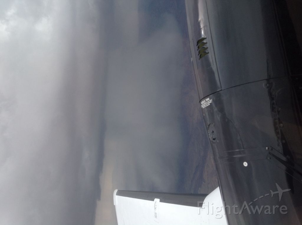 Beechcraft King Air 90 — - Rain shaft on climb out from KLRU.
