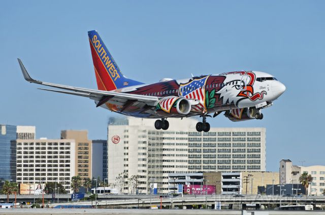 Boeing 737-700 (N918WN) - A Southwest Airlines operated Boeing 737 jet, in special "Illinois One" livery seconds from touch down at the Los Angeles International Airport, LAX, in Westchester, Los Angeles, California. In the background, hotels and office towers along Century Boulevard