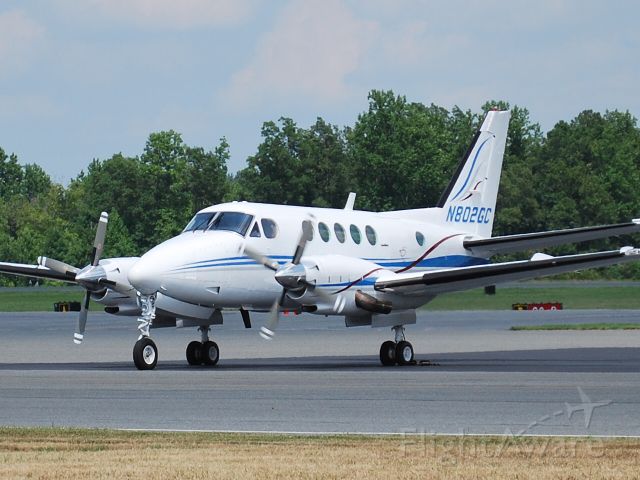 Beechcraft King Air 100 (N802GC) - Left engine starting and getting ready to taxi to runway 2 at Concord Regional Airport (KJQF) - 6/29/11