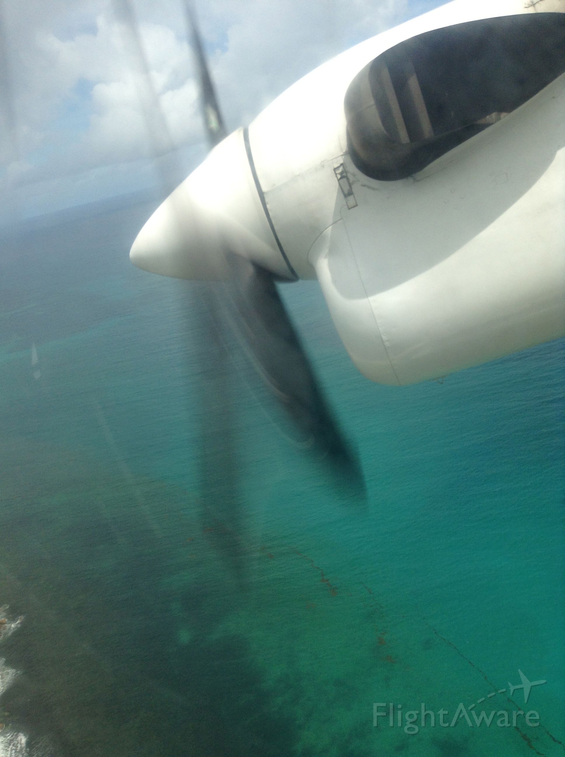 — — - Coming in the engine of the Twin Otter purrs as she approaches the airfield at Praslin Island