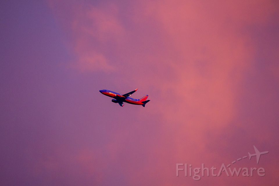 — — - Southwest Airlines departs Charleston International Airport with a beautiful purplish-pink sky behind it!