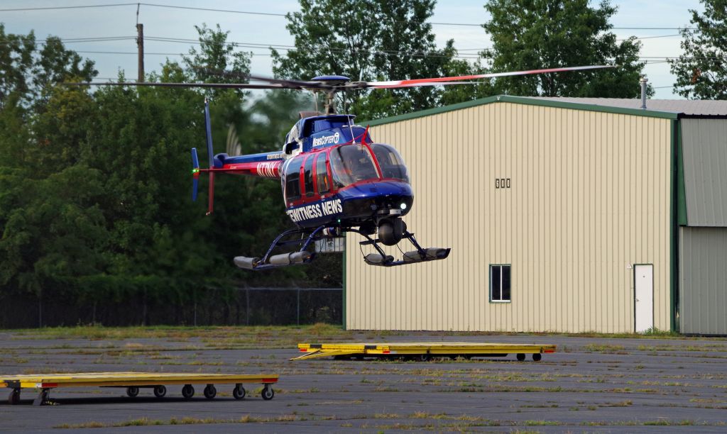 Bell 407 (N77NY) - LINDEN AIRPORT-LINDEN, NEW JERSEY, USA-AUGUST 31, 2020: A news helicopter from one of the local New York City television stations is seen preparing to land after completing its first flight of the morning.