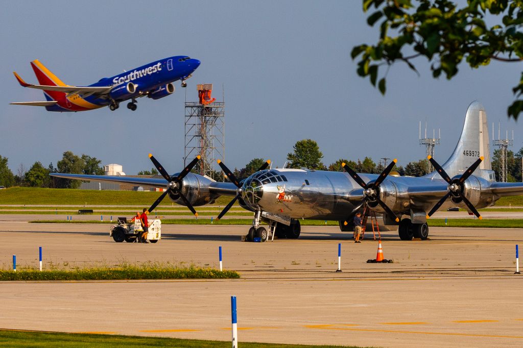 Boeing B-29 Superfortress (46-9972) - Doc, a B29 Superfortress, sits on the ramp as a SouthWest 737 departs KGRR