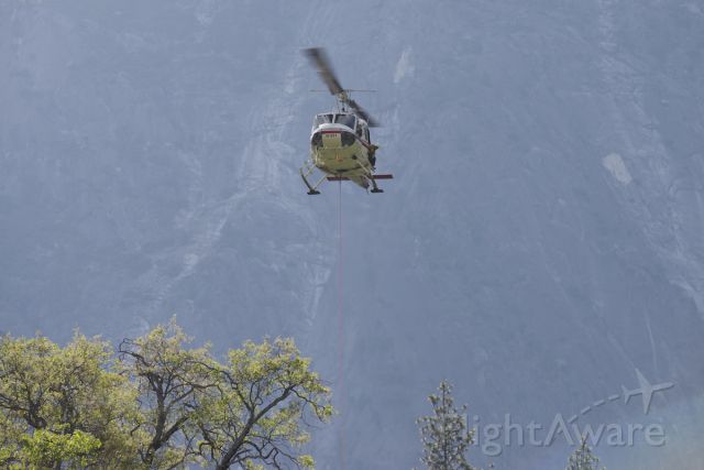 N28HJ — - Watching the park rangers/climb rescue practice their skills. This Bell 205A was taking off from the meadow at the bottom of El Capitan in Yosemite CA - this time with a long line with a ranger hanging below!