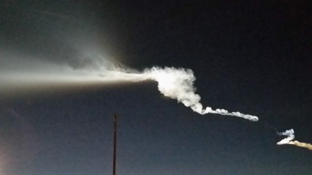 — — - rocket contrails vividly lit by sun after launch