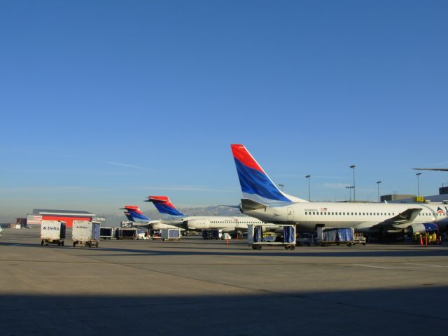 McDonnell Douglas MD-88 (N398DA) - A B737-800 and several MD-90s getting ready for 10am departures.  The delta hangar visible in the background.