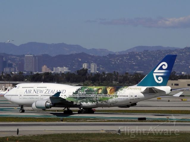 Boeing 747-200 (ZK-NBV) - Air New Zealand B747-400 with Harry Potter paint scheme prepares to cross 25R after touchdown from some far off place.