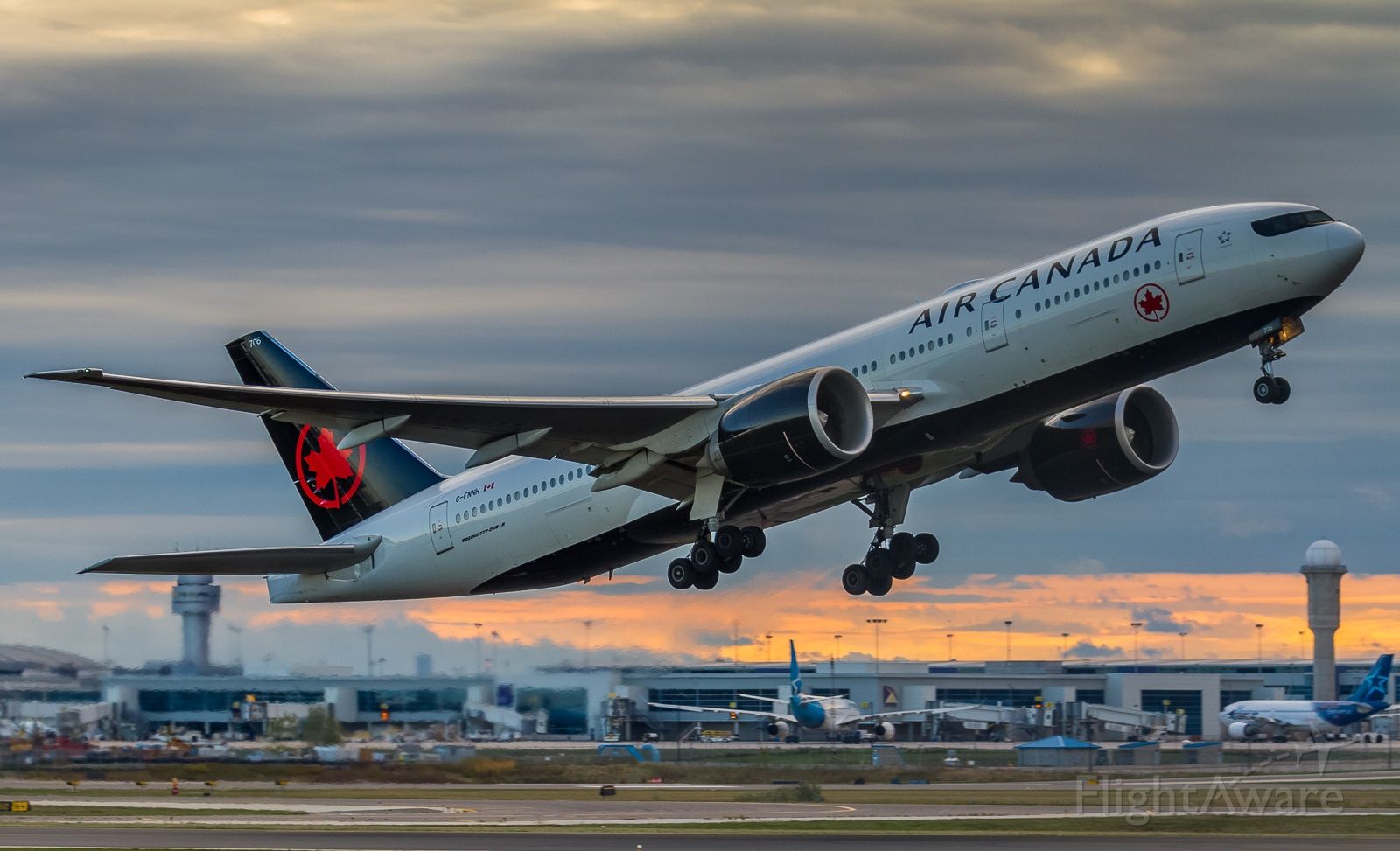 BOEING 777-200LR (C-FNNH) - Air Canada 772 climbs off runway 23 at sunrise