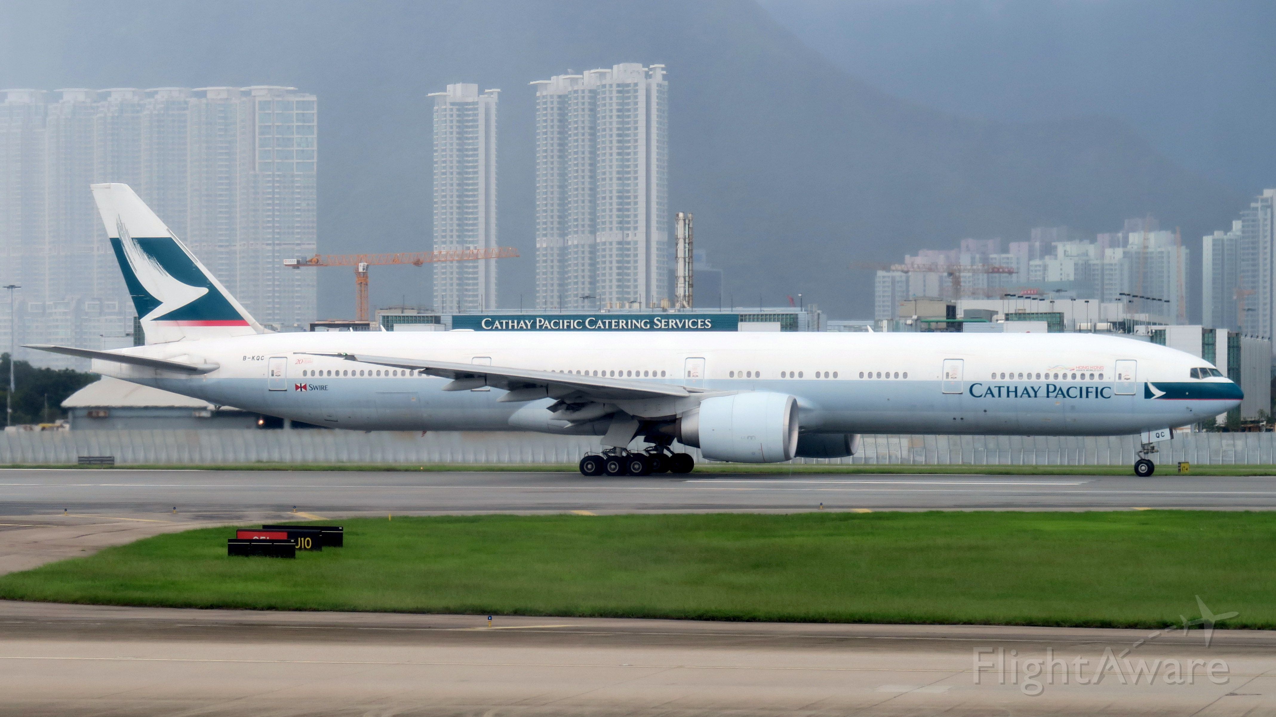 BOEING 777-300 (B-KQC) - CX B-KQC, Boeing 777-367ER at HKG, waiting for take-off on runway 25L, on July 8, 2017.  Taken from CX171, B-LAH, seat 32K.