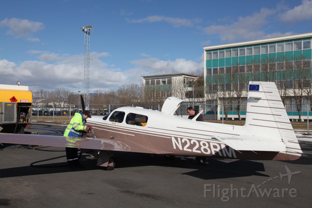 Mooney M-20 Turbo (N228RM) - Refueling at Reykjavik Airport, Iceland. Hotel Loftleider in the background