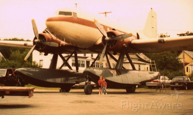— — - Picture of my son (child on the right) with his friend dwarfed by a DC3 on floats. Picture taken at Greenville Maine in 1993. There are videos of this aircraft in action on the web.