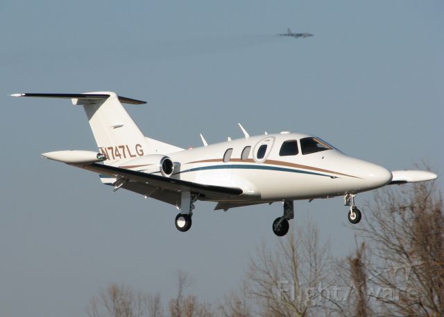 Eclipse 500 (N747LG) - Landing at the Downtown Shreveport airport with a mighty B52H on final for Barksdale Air Force Base in the background.