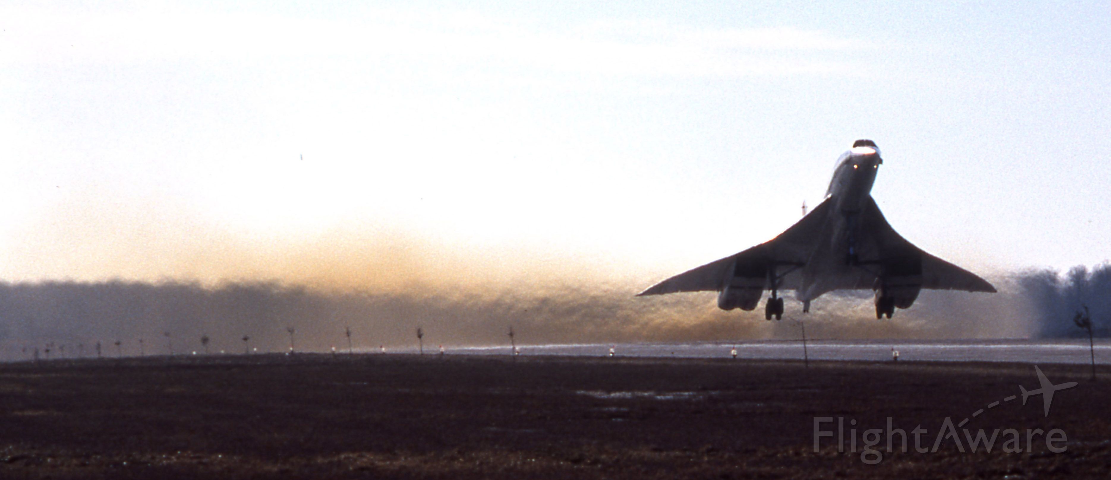 Aerospatiale Concorde (GN94AB) - When KJFK or KIAD and nearby alternates were down because of weather or other factors, the Concordes would fly to CYMX, Mirabel airport near Montreal for fuel.  This photo taken in January 1980 (notice that there is no snow on the ground) is of G-BOAB alias G-N94AB taking off on RWY 06 at YMX on a cold day.  The noise was so loud that my ears rang for a week...