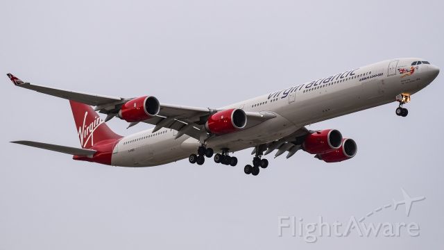 Airbus A340-600 (G-VRED) - On final for 22L on a stormy day.