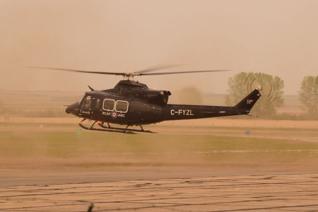 Bell 412 (C-FYZL) - RCAF Bell 412 kicking up some dust on departure fromYQV