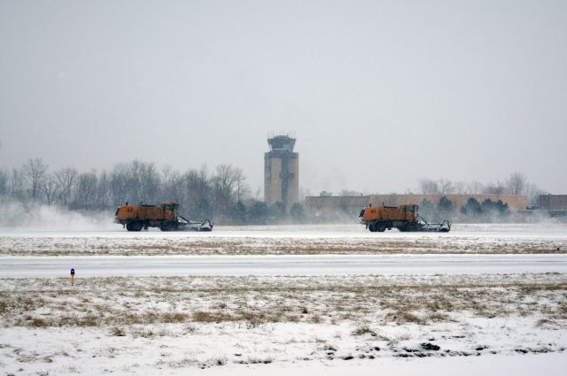 — — - Removing snow on RWY 19 during todays storm
