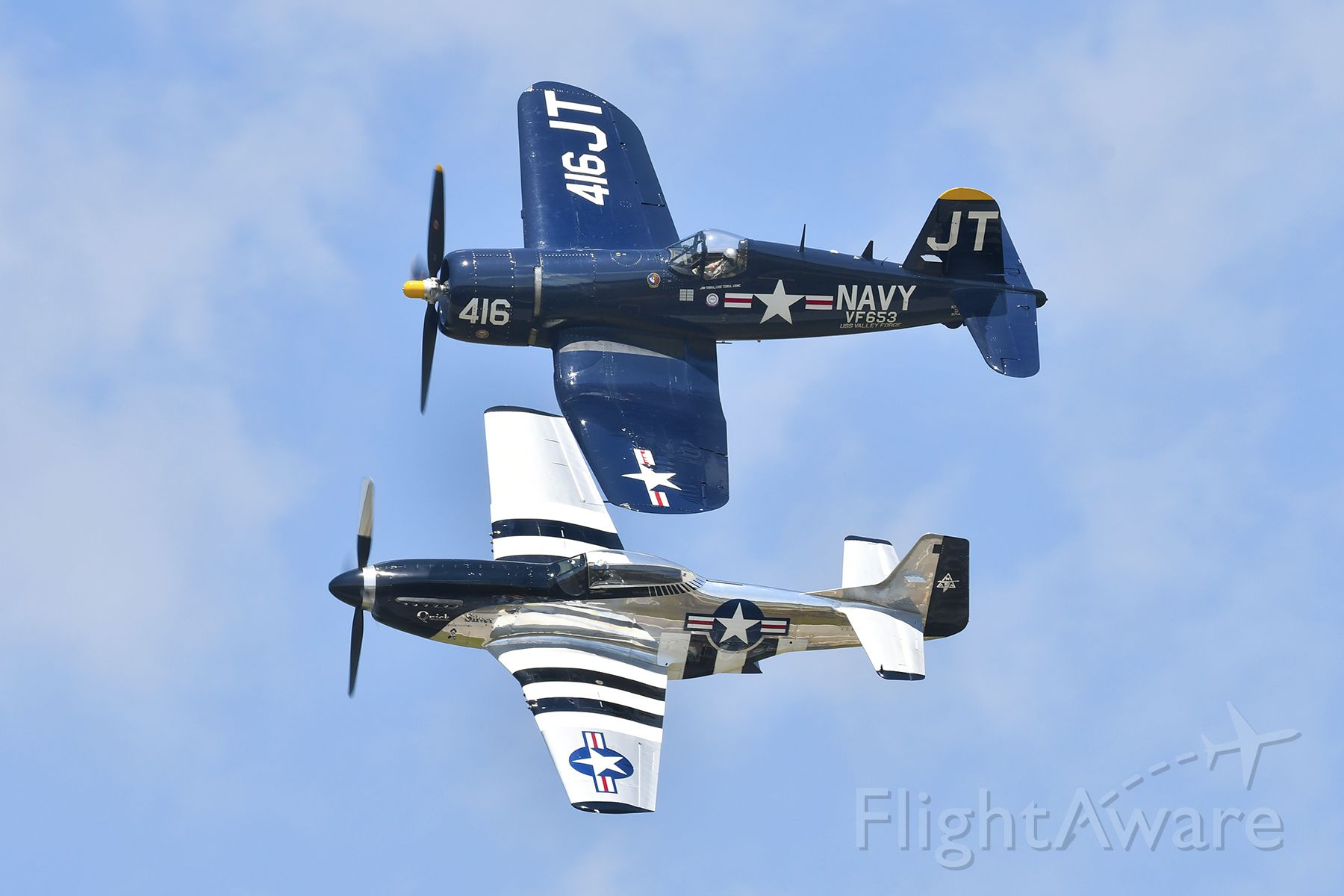 — — - P-51D Mustang and F-4U Corsair in a close formation flight during Battle Creek Air Show 2018.