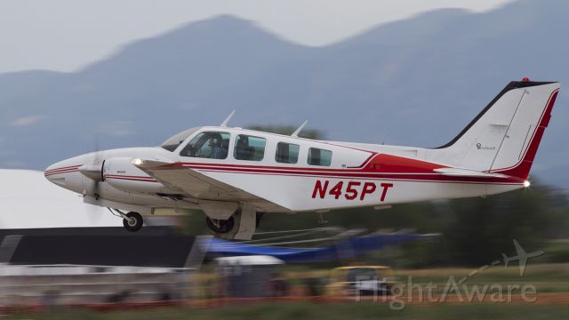 Beechcraft Baron (58) (N45PT) - Nice Baron on a rainy day departure from LMO
