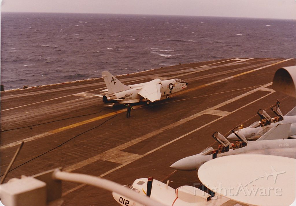 — — - F8 Landing note the elevated wing for lift CVN69 last time F8 Crusader would see a carrier deck, VFP206 decommissioned shortly after this det