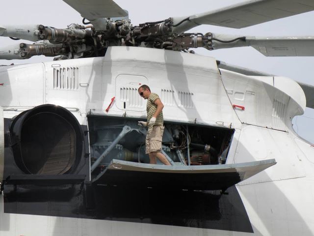 — — - Look how large a Russian Mil Mi26 helicopter is. An easy comparison with crew member standing on door during maintenance.