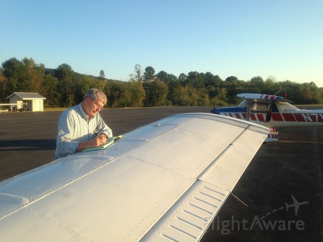 Piper Seneca (N1570X) - The ritual log book signing by an experienced jet pilot professional.  Notice the speed straps on the wing, and vortex generators.  Piper makes a good safe wing producing high lift and forgiving stall characteristics. 