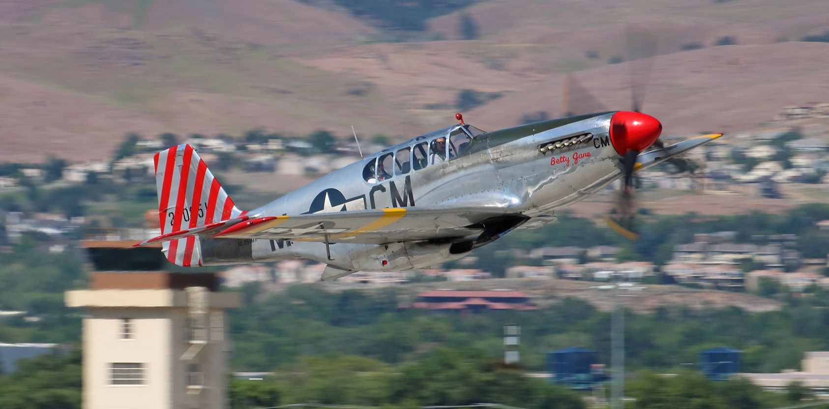 NL251MX — - "Betty Jane," the Collings Foundations P-51 Mustang (North American TP-51C) comes blazing past my rooftop location as it climbs away from Reno Tahoe Internationals runway 34R this morning.