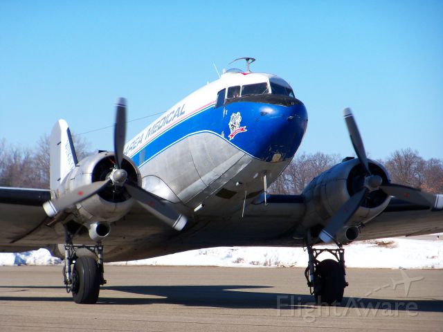 Douglas DC-3 (N982Z) - This beautiful DC3 was originally delivered in 1943 to the U.S. 9th Air Force. Now peacefully serving the needs of people afar, it is seen arriving at Oakland International Airport in Waterford, MI with a load of medical supplies for a Hati relief effort on a beautiful sunny day in March. March 5th 2010
