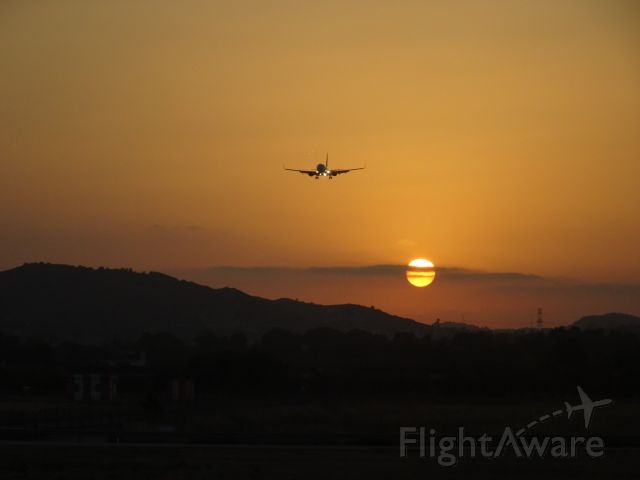 Boeing 737-800 (TRA118) - Watching our colleagues land during sunset Taken from holding point runway 12.