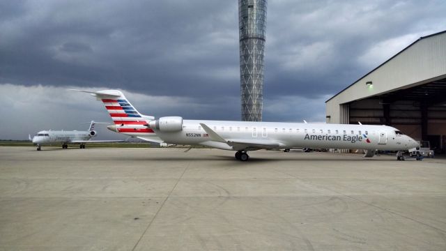 Canadair Regional Jet CRJ-900 (N552NN) - Seeking shelter from the storm outside of the main PSA Airlines Hangar in Dayton, OH.