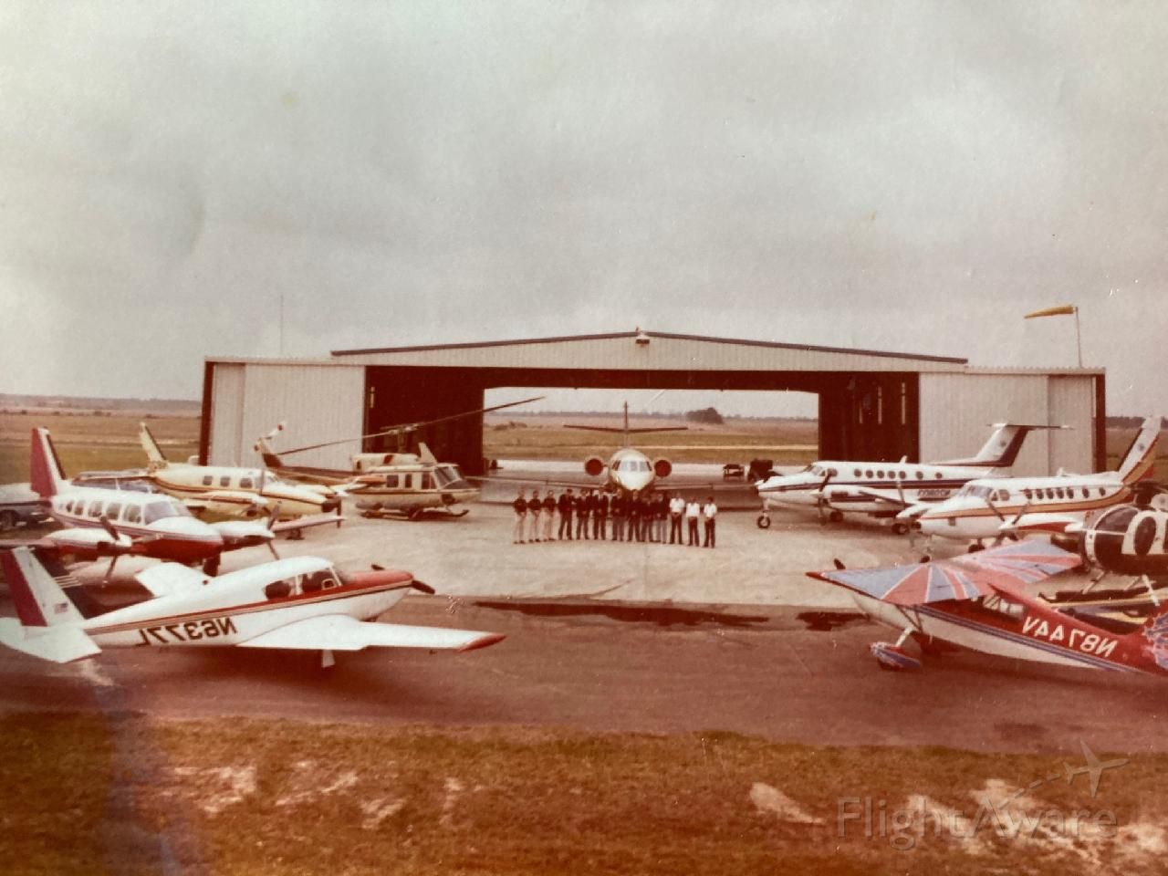 CHAMPION Sky-Trac (N8744V) - Old photo 1976/1977 at Crawford Hanger E-3 KDWH with company pilots and aircraft (image reversed)