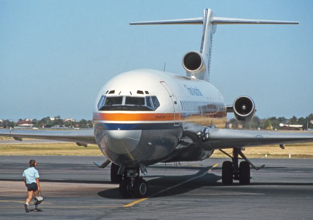 BOEING 727-200 (VH-TBI) - Adelaide, South Australia, February 7, 1982.br /br /In a time-honoured tradition, the first ground crew member to greet an aircraft is the one with the wheel chocks. The length and close fit of the shorts has changed somewhat though.