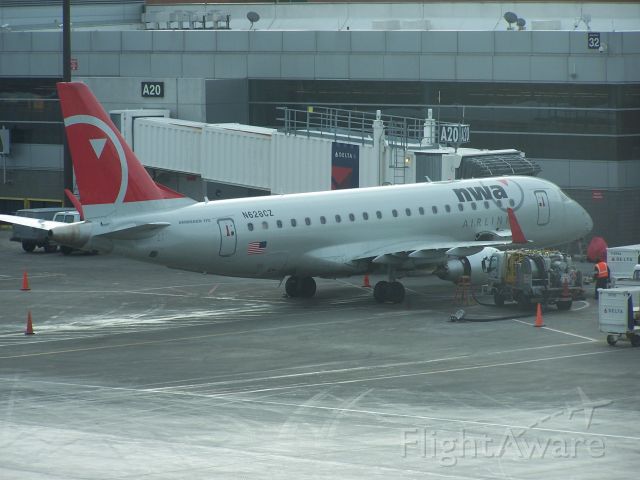 Embraer 170/175 (N628CZ) - N628CZ in Northwest colours on the ramp at Logan Feb 2010