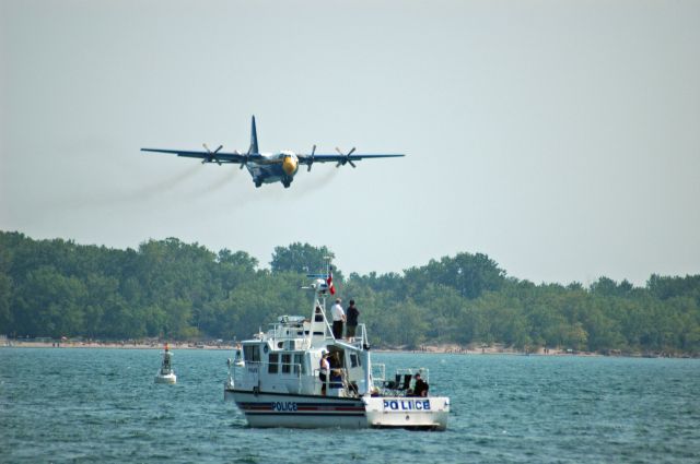 Lockheed C-130 Hercules — - The Blue Angels C-130 "Fat Albert" (164763) taking off from CYTZ to do its demonstration at the Canadian International Airshow (September 7,2009). Here we have Fat Albert and a Toronto Police boat sharing the spotlight.