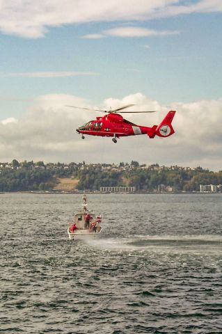 — — - MH-65D Dolphin from Airstation Port Angeles, Washington working with a Coast Guard Utility Boat in Elliott Bay off Seattle