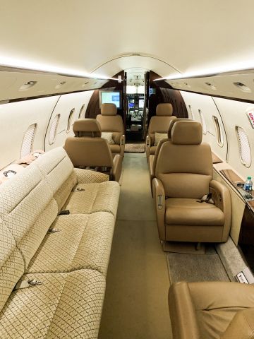 Bombardier Challenger 300 (N517WZ) - Interior of cabin; 3 seat couch and captain chairs.