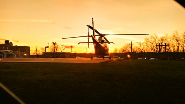 SABCA A-109 (N901XM) - A LifeFlight of Maine helicopter registered as "N901XM" rests on the helipad at Central Maine Medical Center in Lewiston, Maine with the sunset behind the helicopter. Photo taken: Wednesday December 1, 2021 at 4:01 PM. 