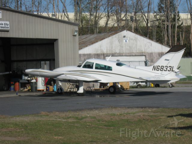 Cessna 310 (N6833L) - Getting maintenance done at Twin City Airmotive. This photo shows her with a new paint job.