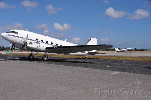 Douglas DC-3 (YV-2119) - DC3 Turbo prop with N271SE Taxing in the background at Opa Locka Arpt in Florida.
