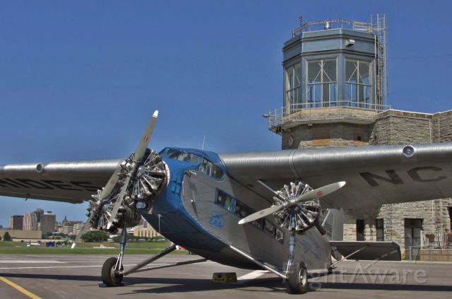 Ford Tri-Motor (N8407) - EAAs 1929 Ford Tri-Motor in front of the Downtown St Paul airport, "Holman Field"  administration building which was built by the WPA in 1939. 