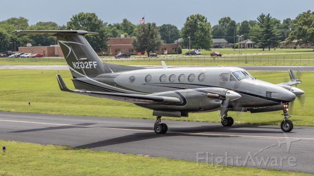 Beechcraft Super King Air 200 (N202FF) - July 6, 2018, Lebanon, Tenn -- This King Air is taxiing out to runway 19 for departure.  A dark sky is visible on the horizon due to heavy thunderstorms in the area.