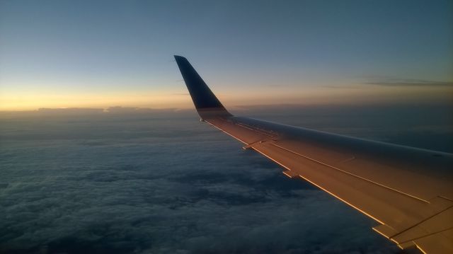 Embraer ERJ-145 — - Just departed KRIC for KIAH on ASQ4339 on September 7. We got above the clouds, and this was my view from seat 23A as the sun was rising.