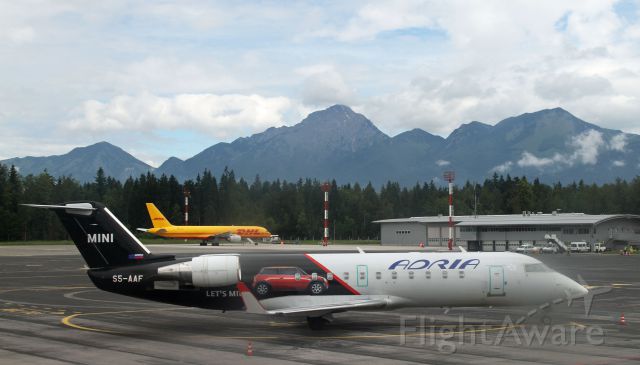 Canadair Regional Jet CRJ-200 (S5AA5) - Bombardier CRJ200 featuring Mini on fuselage and tail, at Ljubljana Airport