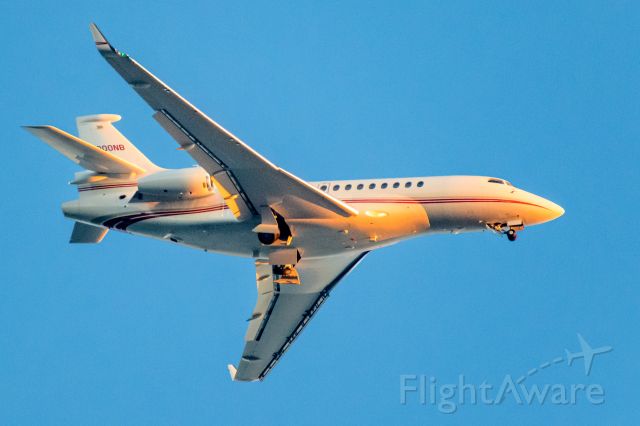 Dassault Falcon 7X (N900NB) - Sunset colors reflect as landing gear is extending on approach.
