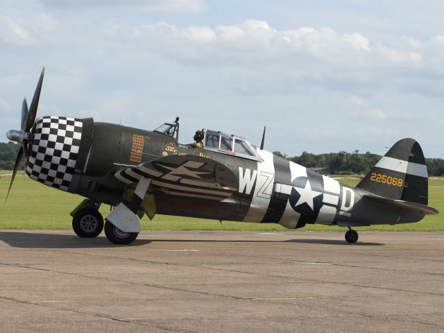 — — - A brute of an aircraft with a brute of an engine. A Republic P-47 Thunderbolt taxies to the flightline after performing a final flypast at Flying Legends 2012, held at the Duxford Air Museum.