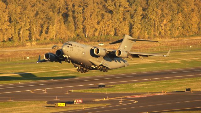 — — - A C-17A taking off from PDX on 28R.