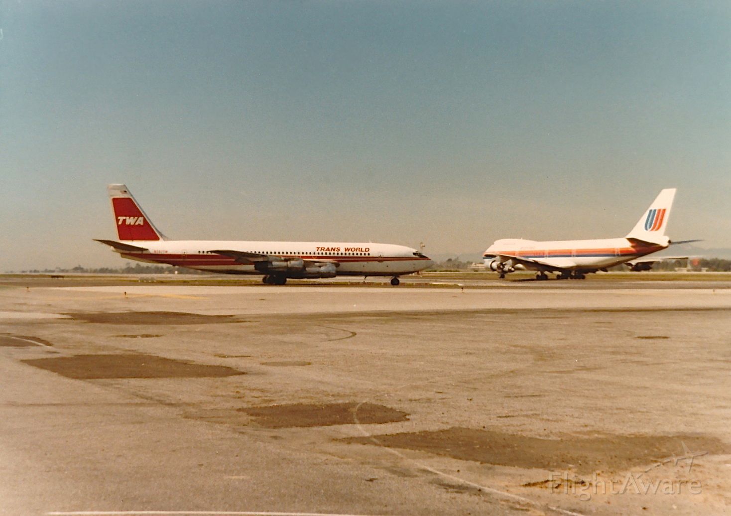 Boeing 707-100 — - TWA B-707 ready for take off with a United B-747 on take off roll in the back ground at KLAX spring 1977