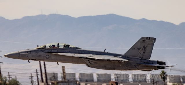 16-5929 — - VFA-122 FA18 screams off the deck (also demonstrating the effect of a high-speed rolling camera shutter with the slightly distorted tanks in the background)